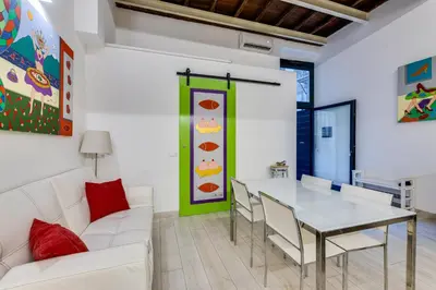 a living room with a white couch and a table at Rome Historic Center LOFT in Rome