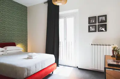 a bedroom with a bed and a large window at TrastevereHome - Santa Cecilia in Trastevere with Balcony in Rome