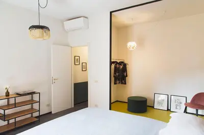 a bedroom with a white bed and a mirror at TrastevereHome - Santa Cecilia in Trastevere with Balcony in Rome