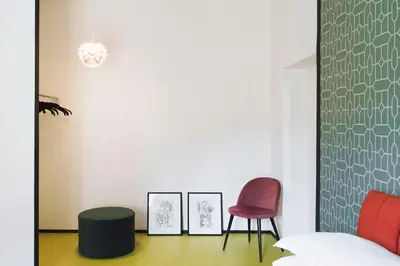 a living room with two chairs and a bed at TrastevereHome - Santa Cecilia in Trastevere with Balcony in Rome
