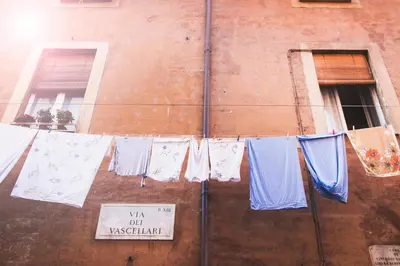 a bunch of clothes hanging on a clothes line at TrastevereHome - Santa Cecilia in Trastevere with Balcony in Rome