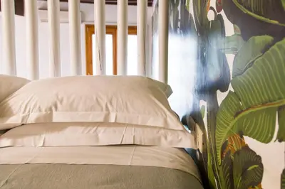 a kitchen with green and white cabinets and a tv at TrastevereHome - Central Monserrato House with Balcony in Rome