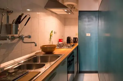 a kitchen with a sink and a bowl on the counter at TrastevereHome - Central Monserrato House with Balcony in Rome