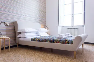 a bedroom with a bed and a window at TrastevereHome - San Cosimato View on Trastevere Square in Rome
