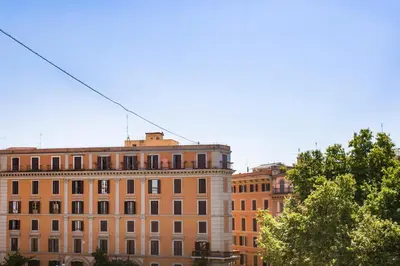 a group of buildings with trees in front of them at TrastevereHome - San Cosimato View on Trastevere Square in Rome