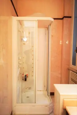 a shower with a glass door in a bathroom at Trevi Nice Holiday - Luxury Apartment in Rome
