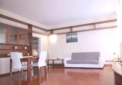 a living room with a couch and a table and chairs at Trevi Nice Holiday - Luxury Apartment in Rome