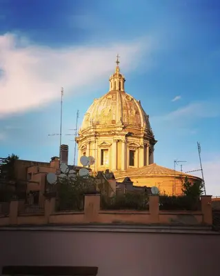 a building with a cross on the top of it at Palazzetto de Lante Appartamento Pinta in Rome