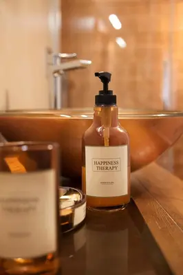 a bottle of soap sitting on a table next to a sink at Palazzetto de Lante Appartamento Pinta in Rome