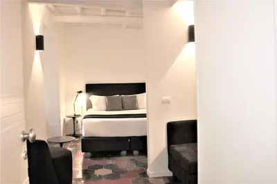 a bedroom with a bed and a couch and a chair at Youroom Vite in Rome