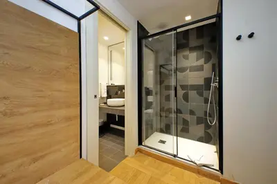 a bathroom with a glass shower and a sink at Youroom Vite in Rome