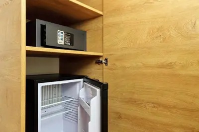 a small refrigerator in a room with a microwave at Youroom Vite in Rome