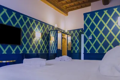 a bedroom with blue and green walls and a bed at Il Campo Marzio in Rome