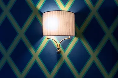 a lamp in a room with a blue wall at Il Campo Marzio in Rome
