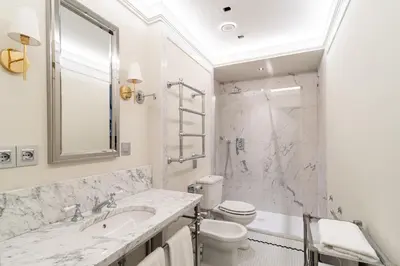 a bathroom with a sink and a toilet and a shower at Room Mate Collection Gran Filippo, Rome-Fontana di Trevi in Rome