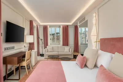 a hotel room with a bed and a desk at Room Mate Collection Gran Filippo, Rome-Fontana di Trevi in Rome