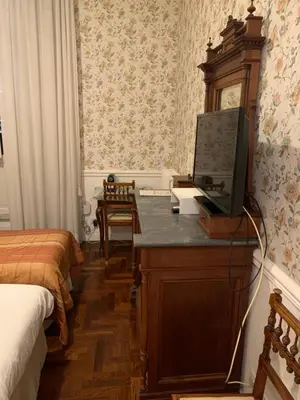 a bedroom with a desk with a television on it at B&b Querini in Rome
