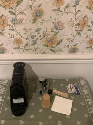 a coffee maker on a table next to a wall at B&b Querini in Rome