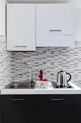 a kitchen with a sink and a counter top at A World Aparts - 61 Margutta in Rome