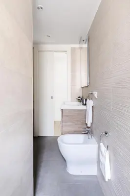 a bathroom with a white tub and a sink at A World Aparts - 61 Margutta in Rome