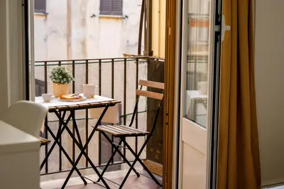 a balcony with a table and a chair on a balcony at Da Fede in Rome