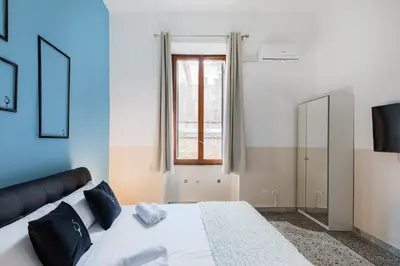 a bedroom with a large bed and a window at A World Aparts - 55 Palermo in Rome