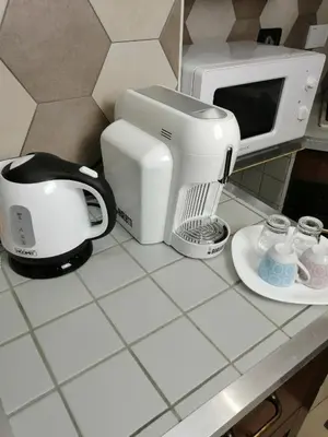a kitchen counter with a coffee maker and a toaster at Trastevere & Gianicolo Sweet Rest in Rome