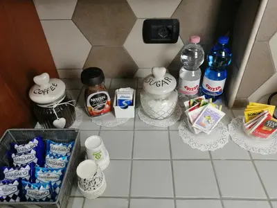 a kitchen counter with a bunch of food and drinks at Trastevere & Gianicolo Sweet Rest in Rome