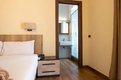 a bedroom with a bed and a sink and a mirror at JSK Suite in Rome
