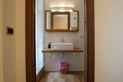 a bathroom with a sink and a mirror at JSK Suite in Rome