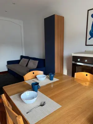 a living room with a wooden table with bowls on it at Home of Joy - Vatican in Rome