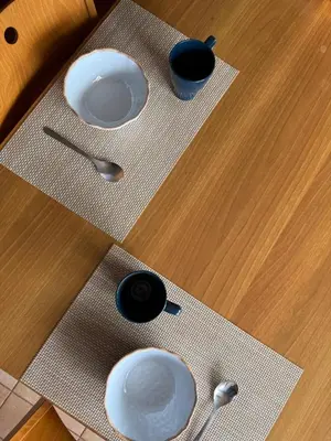 a table with two plates and two cups and spoons at Home of Joy - Vatican in Rome