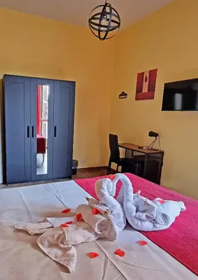a bedroom with towels on a bed with a table at GuestHouse Martin in Rome
