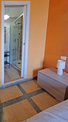 a bedroom with a bed and a sliding glass door at GuestHouse Martin in Rome