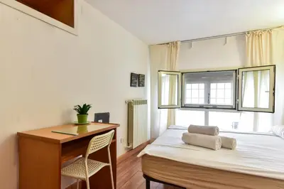 a bedroom with a bed and a desk and a window at Center Rome Termini Rooms & Apartment Sale in Rome