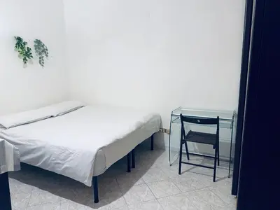 a bedroom with a bed and a table and a chair at Center Rome Termini Rooms & Apartment Sale in Rome