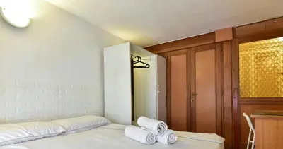 a bedroom with a bed with towels on it at Center Rome Termini Rooms & Apartment Sale in Rome