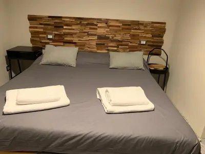 a bed with two white towels on top of it at B&B Nonna Marcella in Rome