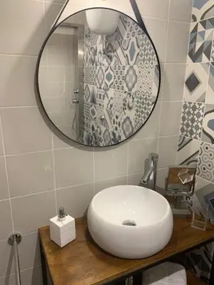 a bathroom with a white sink and a mirror at B&B Nonna Marcella in Rome