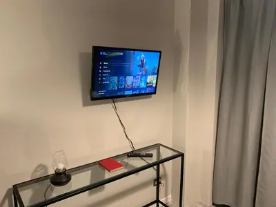 a living room with a tv on the wall at B&B Nonna Marcella in Rome