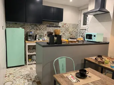 a kitchen with a refrigerator and a table in it at B&B Nonna Marcella in Rome