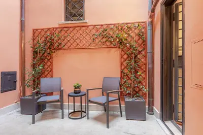 two chairs and a table on a patio at Suite Italy Roma in Rome
