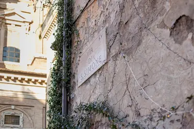 a sign on the side of a building at Suite Italy Roma in Rome