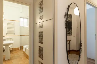 a bathroom with a mirror and a sink at Mirabella Apartment in Rome