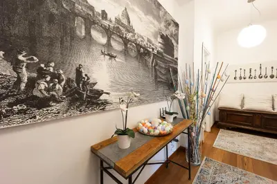 a room with a table and a painting on the wall at Mirabella Apartment in Rome