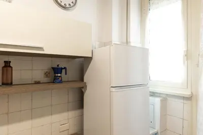 a white refrigerator in a kitchen with a window at Mirabella Apartment in Rome