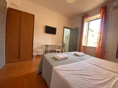 a bedroom with a bed with two towels on it at Milazzo Luxury Home roma in Rome