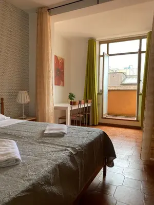 a bedroom with a bed and a large window at Milazzo Luxury Home roma in Rome
