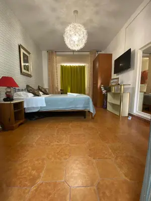 a large bedroom with a bed and a chandelier at Milazzo Luxury Home roma in Rome