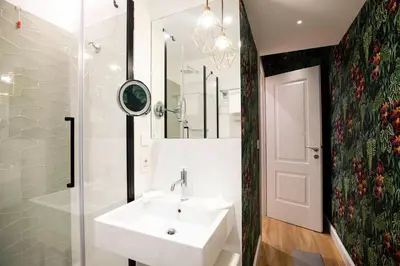 a bathroom with a sink and a shower and a mirror at Vicario Suites in Rome